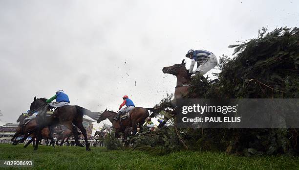 Teaforthree ridden by Nick Scholfield is unseated at The Chair during the Grand National horse race at Aintree Racecourse in Liverpool, north-west...