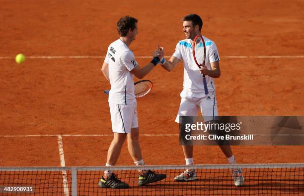 Andy Murray and Colin Fleming of Great Britain celebrate match point against Simone Bolelli and Fabio Fognini of Italy during day two of the Davis...