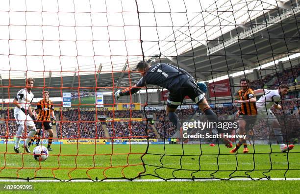 George Boyd of Hull City scores the match wining goal past goalkeeper Michel Vorm of Swansea during the Barclays Premier league match between Hull...