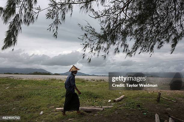 Burmese man walks back to his motorbike after hunting with a slingshot inside the planned Dawei SEZ on August 3, 2015 in Nabule, Myanmar. The...