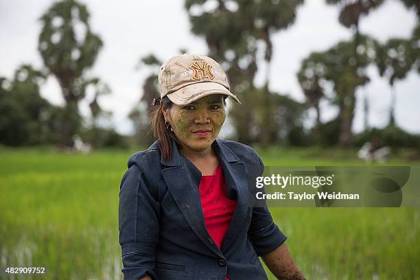 Female rice farmer poses for a portrait in a field inside the planned Dawei SEZ on August 3, 2015 in Nabule, Myanmar. The controversial,...