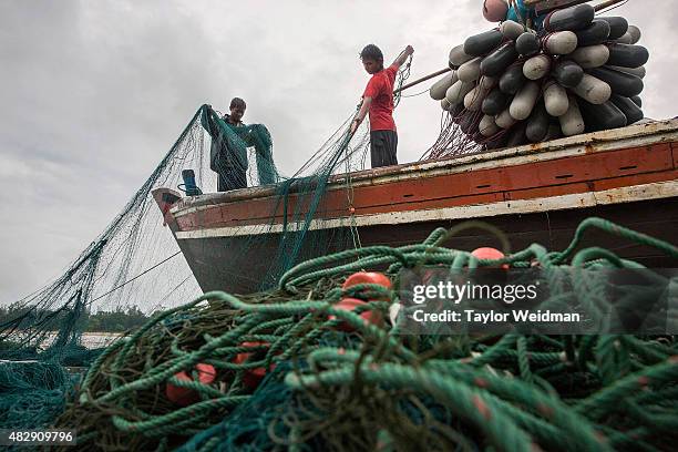 Burmese fishermen prepare their nets before a voyage near the planned Dawei SEZ on August 2, 2015 Bawar Village, Myanmar. The controversial,...