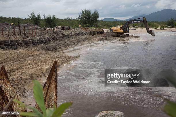 Construction workers build a small, interim port inside the planned Dawei SEZ on August 3, 2015 in Ngapitat, Myanmar.The controversial, multi-billion...