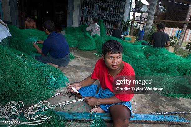Burmese workers make 6,000 kyat per day making nets for fishing boats near the planned Dawei SEZ on August 3, 2015 in Pantininn, Myanmar. The...