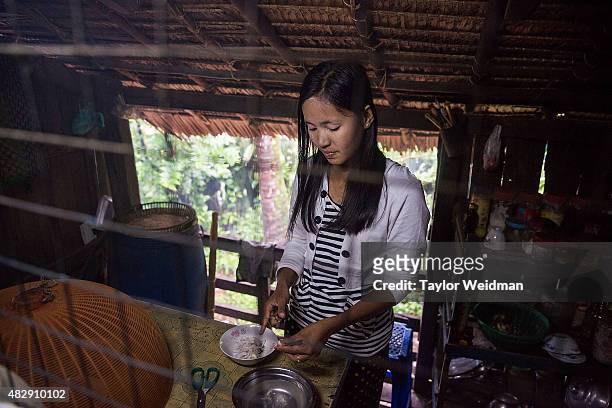 Burmese woman makes lunch in her home near the planned Dawei SEZ on August 4, 2015 in Pantininn, Myanmar. The controversial, multi-billion dollar...
