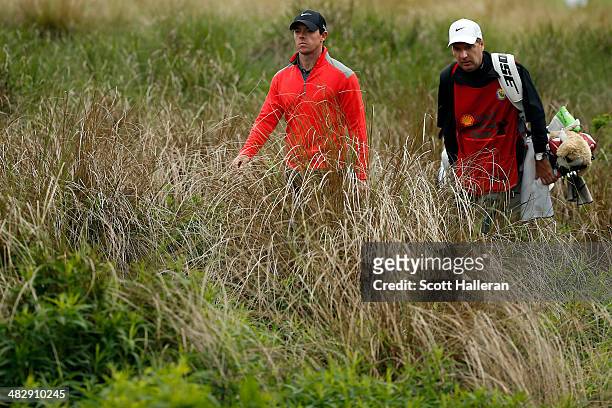 Rory McIlroy of Northern Ireland walks with his caddy J.P. Fitzgerald to the twelfth hole during round three of the Shell Houston Open at the Golf...