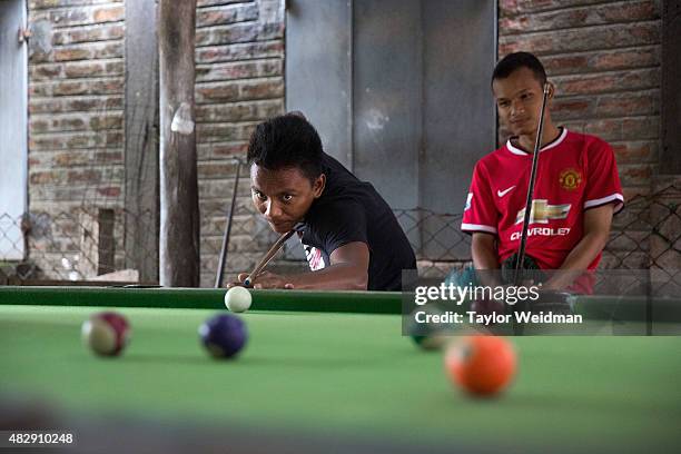 Burmese men play pool in a hall near the planned Dawei SEZ on August 4, 2015 in Maungmagan, Myanmar.The controversial, multi-billion dollar Dawei...