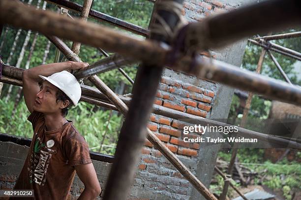 Burmese construction workers build an elementary school near the planned Dawei SEZ on August 4, 2015 in Maungmagan, Myanmar.The controversial,...