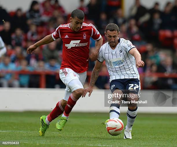 Lee Peltier of Nottingham Forest tackles Scott McDonald of Millwall during the Sky Bet Championship match between Nottingham Forest and Millwall at...