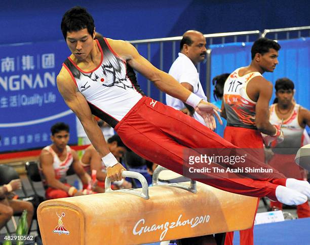 Hisashi Mizutori of Japan competes in the Pommel Horse of the Men's Team of the Artistic Gymnastics during day one of the Guangzhou Asian Games at...