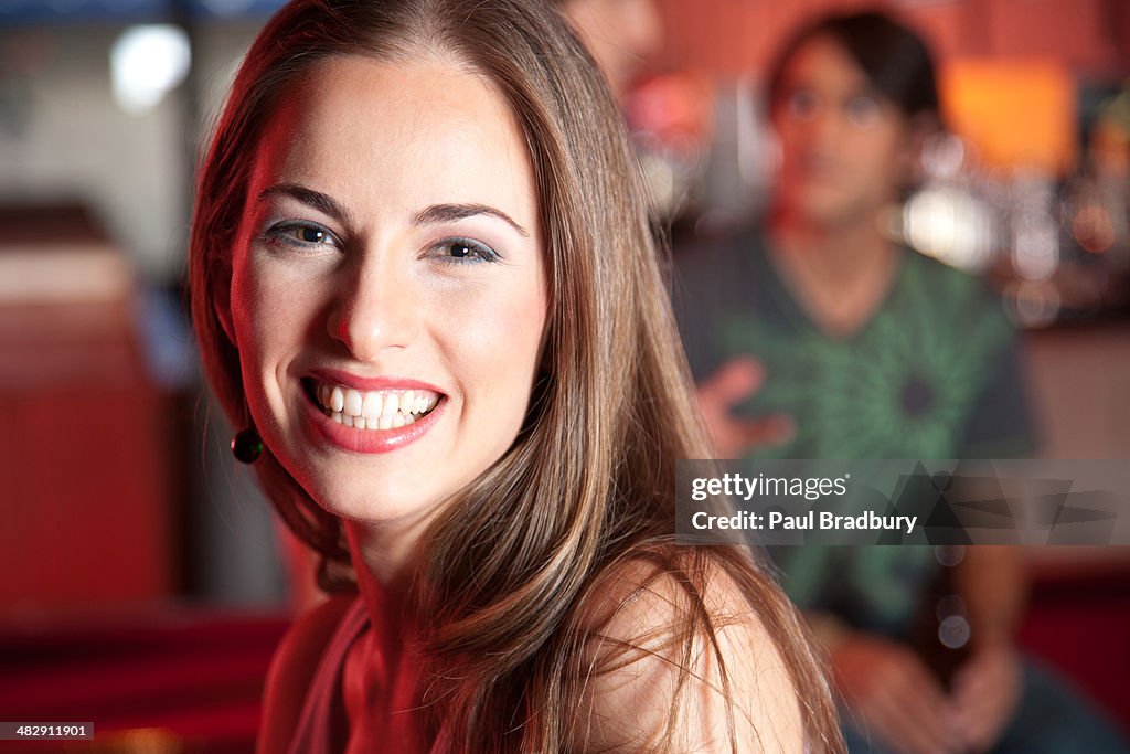 Woman smiling in nightclub