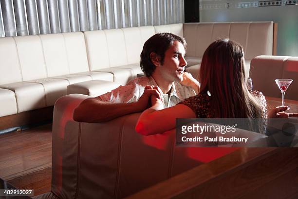couple relaxing on living room sofa  - young couple date night wine stock pictures, royalty-free photos & images