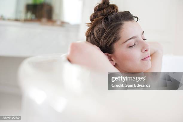 woman relaxing in bubble bath - bad thoughts stockfoto's en -beelden