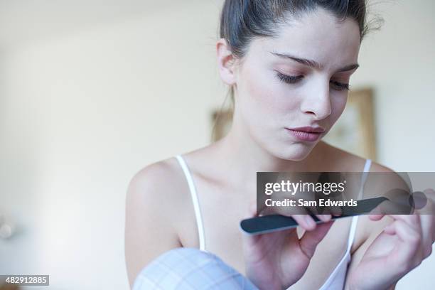 woman using emery board on fingernails  - home manicure stock pictures, royalty-free photos & images