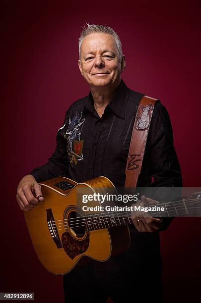 Portrait of Australian virtuoso guitarist Tommy Emmanuel photographed with his Maton Custom EGB808 acoustic guitar in London, on October 27, 2014.