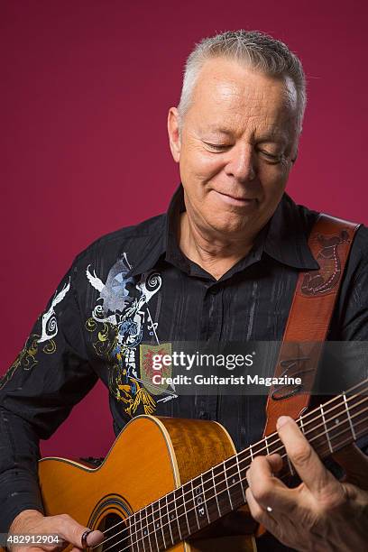 Portrait of Australian virtuoso guitarist Tommy Emmanuel photographed with his Maton Custom EGB808 acoustic guitar in London, on October 27, 2014.