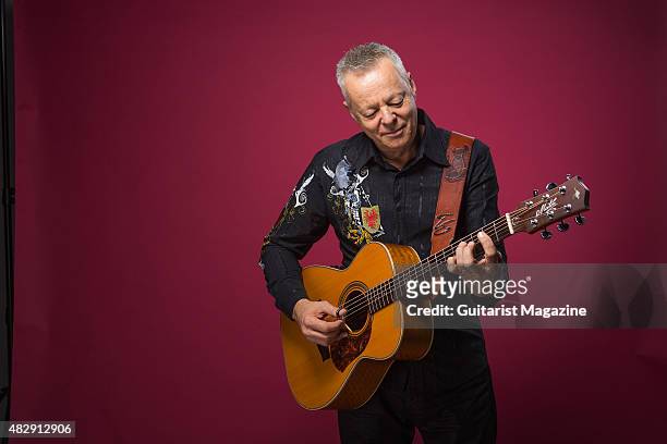 Portrait of Australian virtuoso guitarist Tommy Emmanuel photographed with his Maton Custom EGB808 acoustic guitar in London, on October 27, 2014.