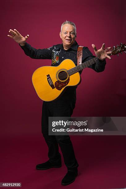 Portrait of Australian virtuoso guitarist Tommy Emmanuel photographed with his Maton Custom EGB808 acoustic guitar in London, on October 27, 2014.