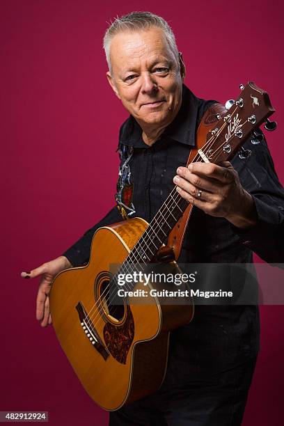 Portrait of Australian virtuoso guitarist Tommy Emmanuel photographed with his Maton Custom EGB808 acoustic guitar in London, on October 27, 2014.