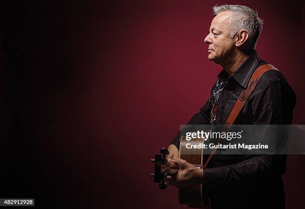 Portrait of Australian virtuoso guitarist Tommy Emmanuel photographed with his Maton Custom EGB808 acoustic guitar in London, on October 27, 2014.