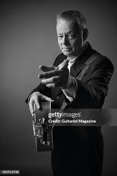 Portrait of Australian virtuoso guitarist Tommy Emmanuel photographed with his Maton Custom EGB808 acoustic guitar in London, on October 27, 2014.