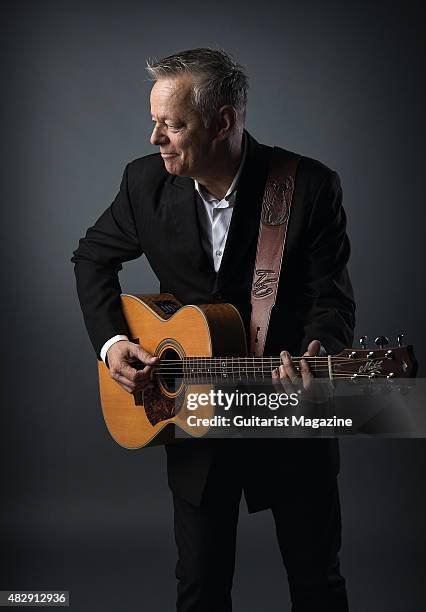 Portrait of Australian virtuoso guitarist Tommy Emmanuel photographed with his Maton Custom EGB808 acoustic guitar in London, on October 27, 2014.