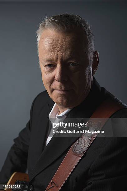 Portrait of Australian virtuoso guitarist Tommy Emmanuel photographed with his Maton Custom EGB808 acoustic guitar in London, on October 27, 2014.