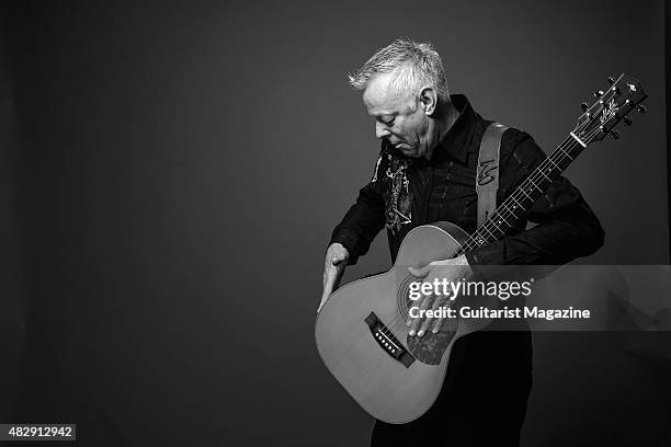 Portrait of Australian virtuoso guitarist Tommy Emmanuel photographed with his Maton Custom EGB808 acoustic guitar in London, on October 27, 2014.