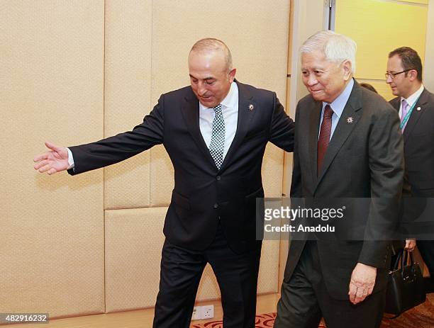 Turkish Foreign Minister Mevlut Cavusoglu meets Philippine Foreign Secretary Albert Del Rosario ahead of the 48th Association of Southeast Asian...