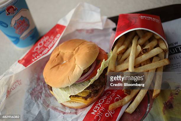 Wendy's Co. Classic double cheeseburger and french fries are arranged for a photograph at a restaurant location in Mt. Vernon, Illinois, U.S., on...