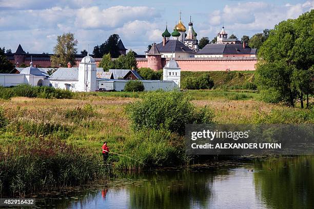 Russian woman fishes in a river on August 4, 2015 in Suzdal, a tourist spot being part of ancient Russia cities, known as the "Golden Ring". AFP...