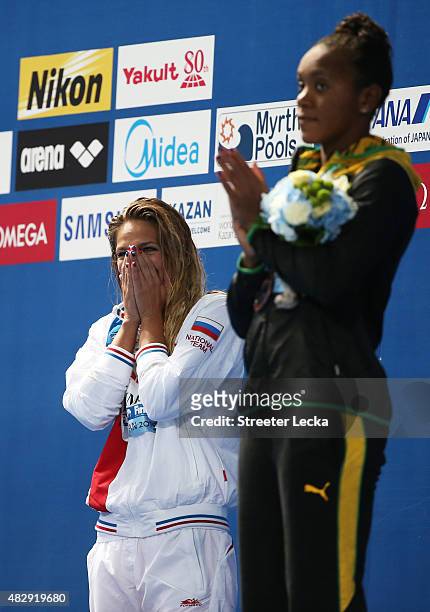 Gold medallist Yuliya Efimova of Russia reacts with bronze medallist Alia Atkinson of Jamaica during the medal ceremony for the Women's 100m...