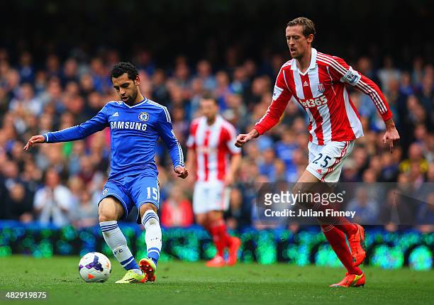 Mohamed Salah of Chelsea is marshalled by Peter Crouch of Stoke City during the Barclays Premier League match between Chelsea and Stoke City at...