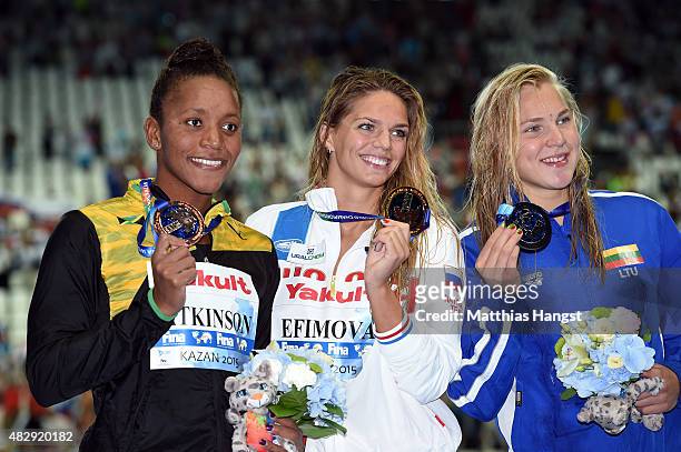 Gold medallist Yuliya Efimova of Russia poses with silver medallist Ruta Meilutyte of Lithuania and bronze medallist Alia Atkinson of Jamaica during...