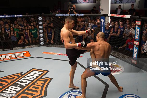 Vicente Luque kicks Hayder Hassan during the filming of The Ultimate Fighter: American Top Team vs Blackzilians on February 27, 2015 in Coconut...