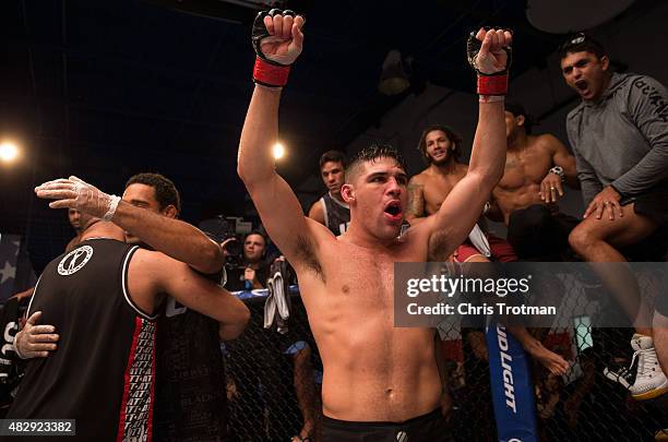 Vicente Luque raises his hands as he waits for the judges decision after his fight against Hayder Hassan during the filming of The Ultimate Fighter:...