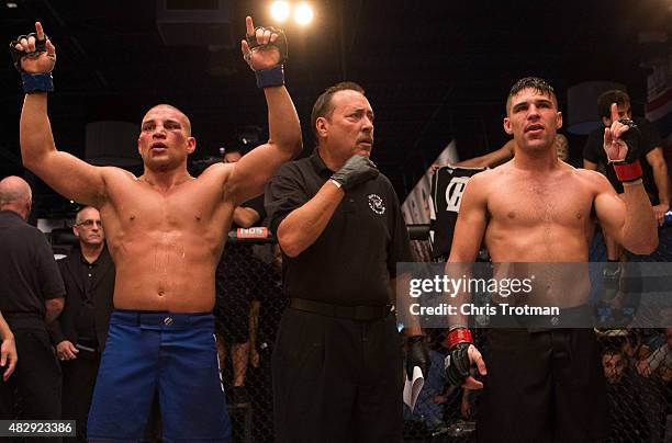 Vicente Luque and Hayder Hassan raise their hands as they wait for the judges decision after their three round fight during the filming of The...