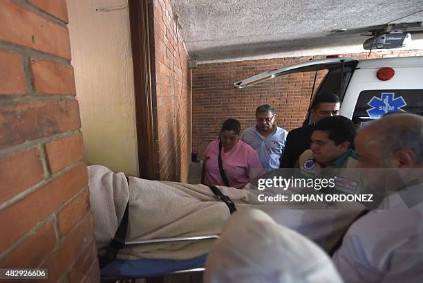 Former Guatemalan dictator Jose Efrain Rios Montt, arrives on a trolley at a private clinic in Guatemala City on August 4, 2015 to be submitted by...