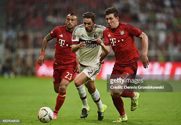 Arturo Vidal and Pierre-Emile Hojbjerg of FC Bayern Muenchen chase Mattia De Sciglio of AC Milan during the Audi Cup 2015 match between FC Bayern...