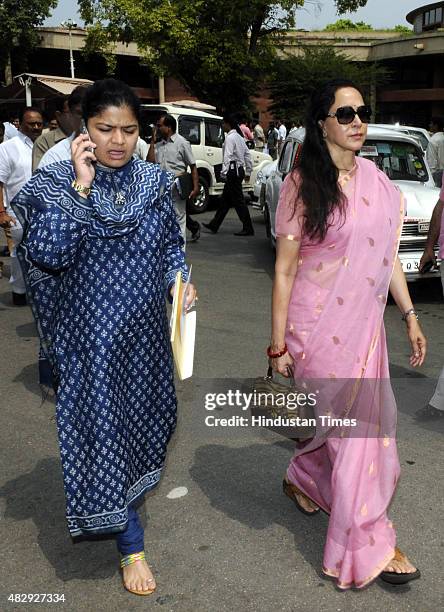 Bollywood actor and BJP MP Hema Malini with BJP MP Poonam Mahajan after attending the BJP Parliamentary Board Meeting during the Monsoon Session of...