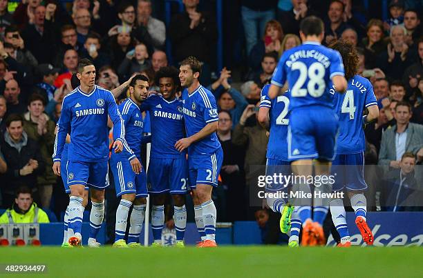 Willian of Chelsea is congratulated by Branislav Ivanovic and Mohamed Salah of Chelsea on scoring their third goal during the Barclays Premier League...