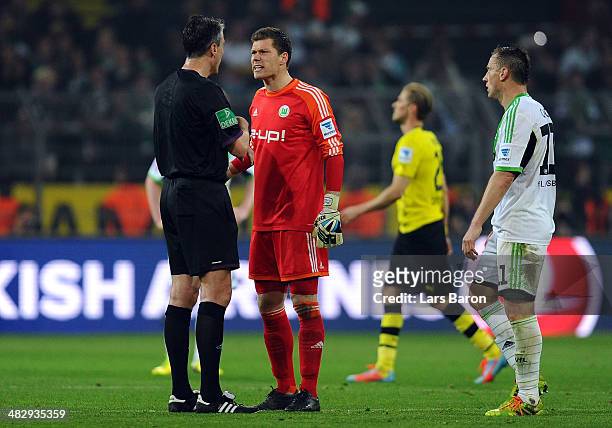 Goalkeeper Max Gruen of Wolfsburg duscusses with referee Knut Kircher after loosing the Bundesliga match between Borussia Dortmund and VfL Wolfsburg...