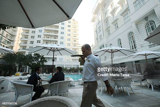 Waiter walks at the upscale Copacabana Palace hotel overlooking Copacabana beach, which will be a venue site for various Olympic events, ahead of the...