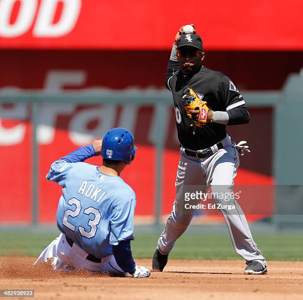 Alexei Ramirez of the Chicago White Sox throws past Norichika Aoki of the Kansas City Royals to first to complete a double play in the first inning...
