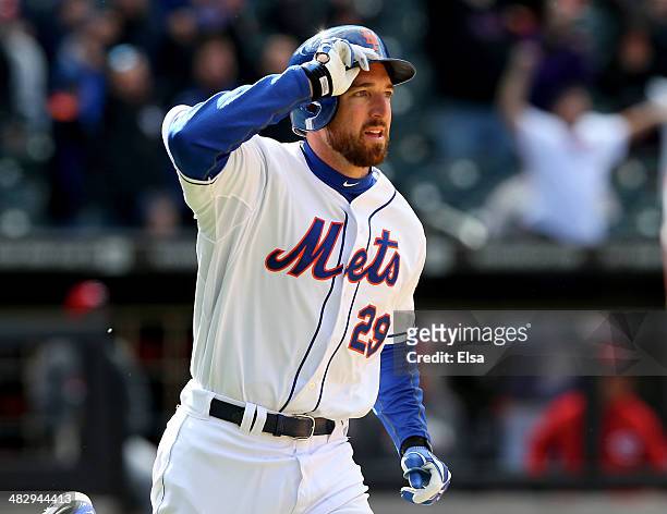 Ike Davis of the New York Mets celebrates his walk off home run as he heads around first in the bottom of the ninth inning against the Cincinnati...