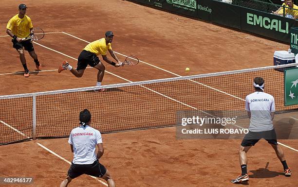 Colombian tennis player Robert Farah returns the ball next to teammate Juan Sebastian Cabal to Dominican Republic's tennis player Victor Estrella and...