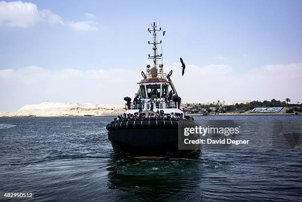 Journalists are taken out on a boat during a press conference for the opening of the Suez Canal Authority on June 13, 2015 in Ismailia, Egypt. The...