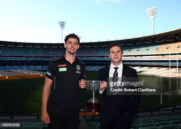 Scott Pendlebury of the Magpies and Marc Murpy of the Blues pose with the Peter Mac Cup, during the the Peter Mac Cup Breakfast at Melbourne Cricket...