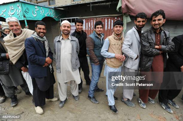 Men wait in line as Afghans defy Taliban threats and vote in record numbers in presidential elections on April 5 in Kabul, Afghanistan. On a day that...