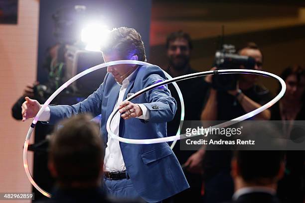 Host Markus Lanz perfoms with a hula hoop during the 'Wetten, dass..?' tv show on April 5, 2014 in Offenburg, Germany.